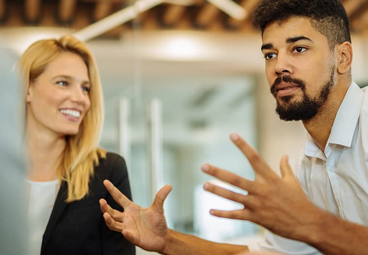 Man explaining to interested coworker